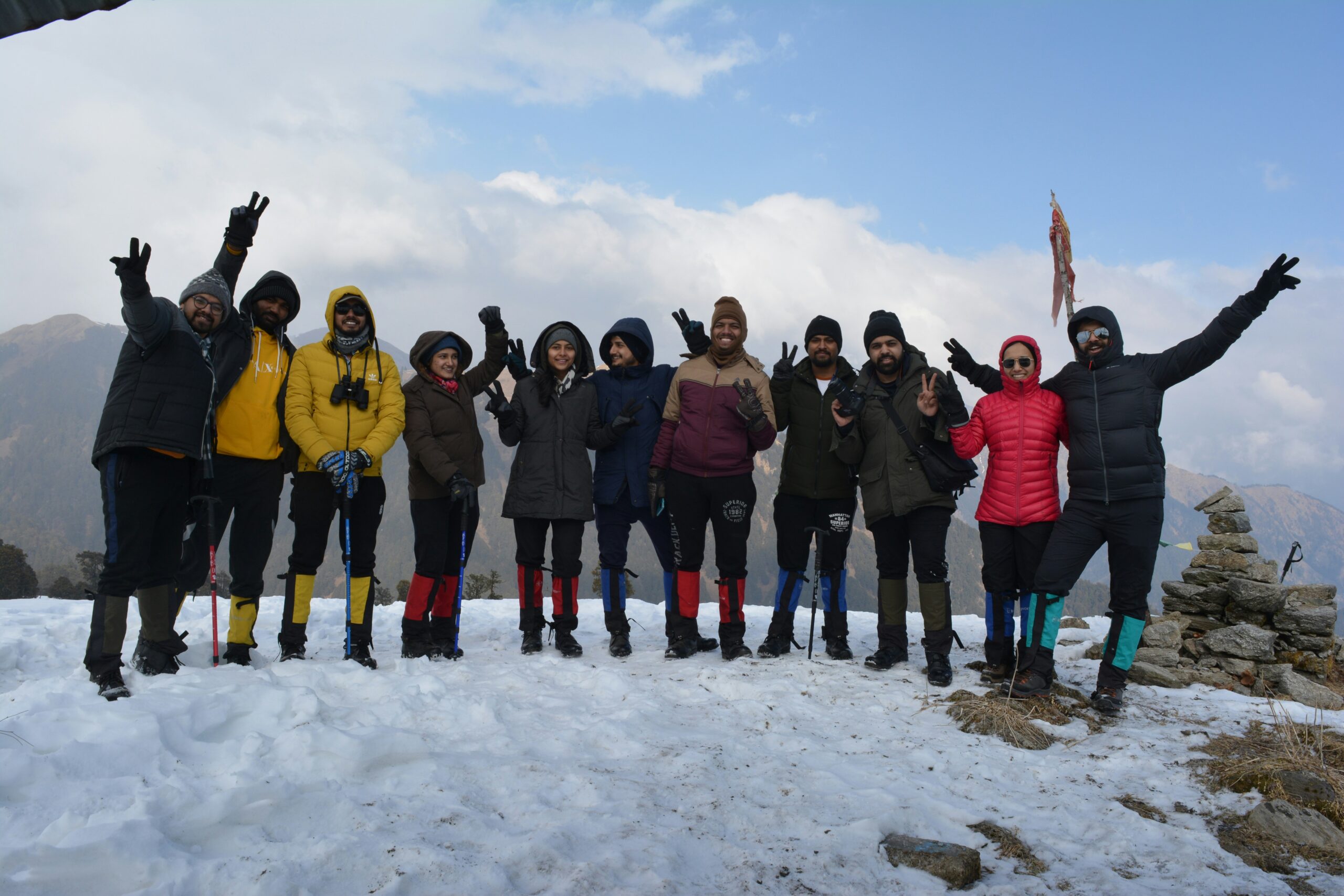 a group of people posing for a photo on a snowy mountain with Raithal Hills Trek Company In India